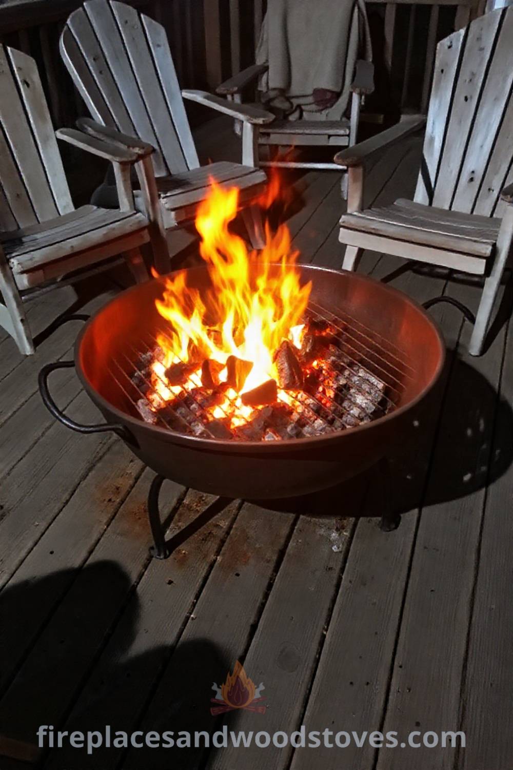 Heavy-duty metal fire pit on a rustic wooden deck surrounded by mismatched patio chairs, flickering flames creating a cozy atmosphere perfect for gatherings. Visit patioandhomefurniture.com for stylish outdoor design ideas that will wow your guests.
